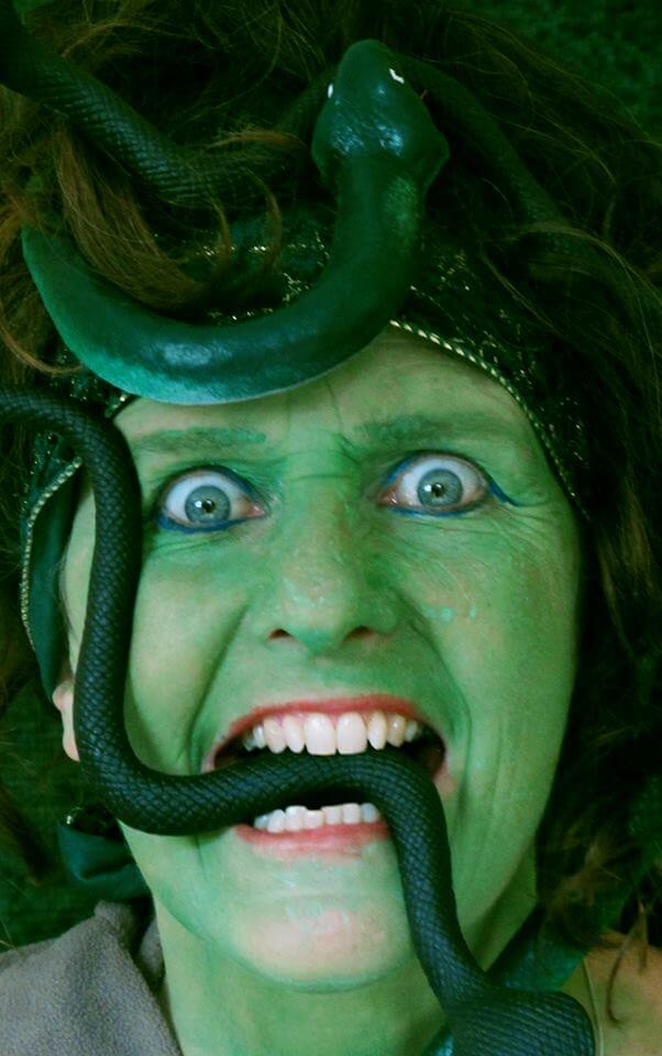 green lady with fake snakes in her hair and mouth