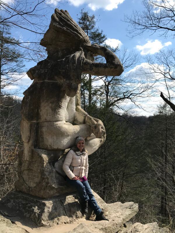 Person standing beside Indian Statue in Wissahickon park philadelphia