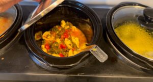 tortellini soup in a crock pot ready for the book club soup swap