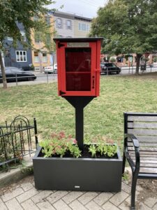 Image of a red Little Free Library in Cianfrani Park in Philadelphia 